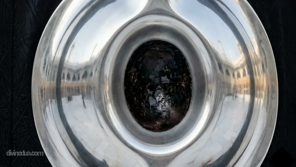 Macro close-up of the sacred Black Stone of Kaaba encased in its polished silver frame, showing the individual fragments and Kiswah cloth.