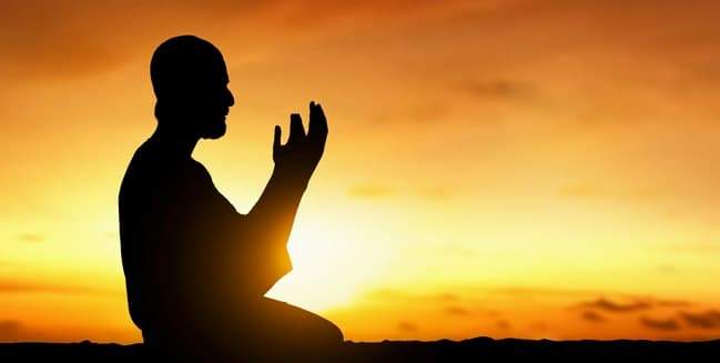 A Muslim praying Fajr (dawn prayer) during Ramadan